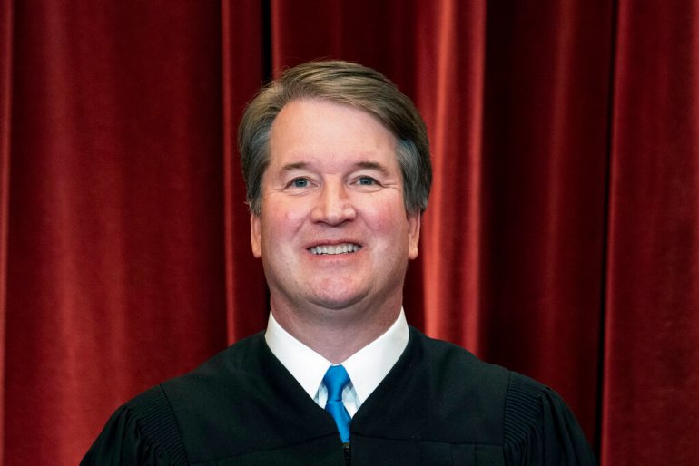 Associate Justice Brett Kavanaugh stands during a group photo at the Supreme Court in Washington