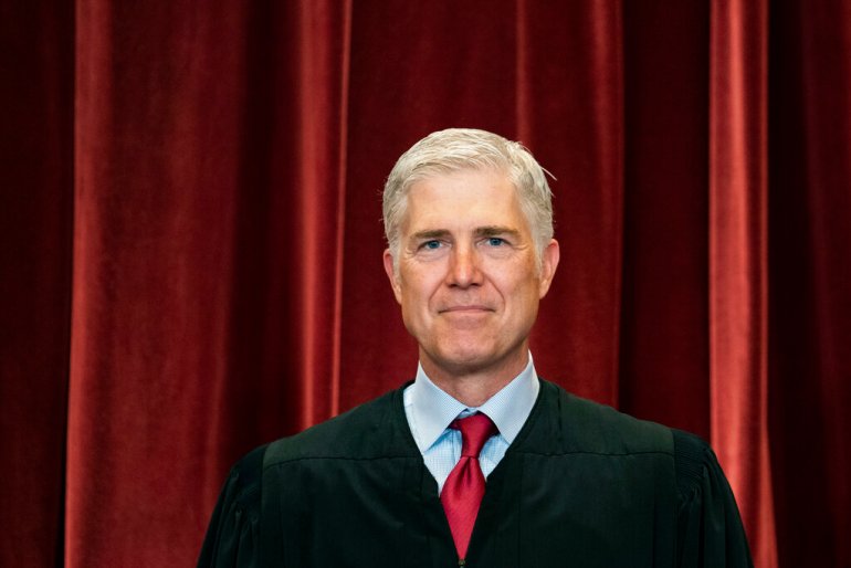 Associate Justice Neil Gorsuch stands during a group photo at the Supreme Court.