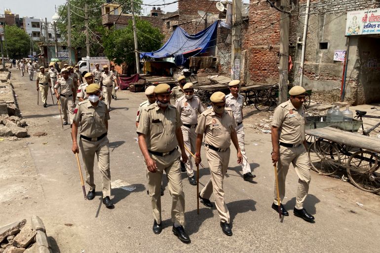 Policemen patrol a day after communal clashes in Jahangirpuri, a neighborhood in northwest Delhi,