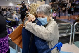 Families embrace after a flight from Los Angeles arrived at Auckland International Airport as New Zealand's border opened for visa-waiver countries Monday, May 2, 2022.