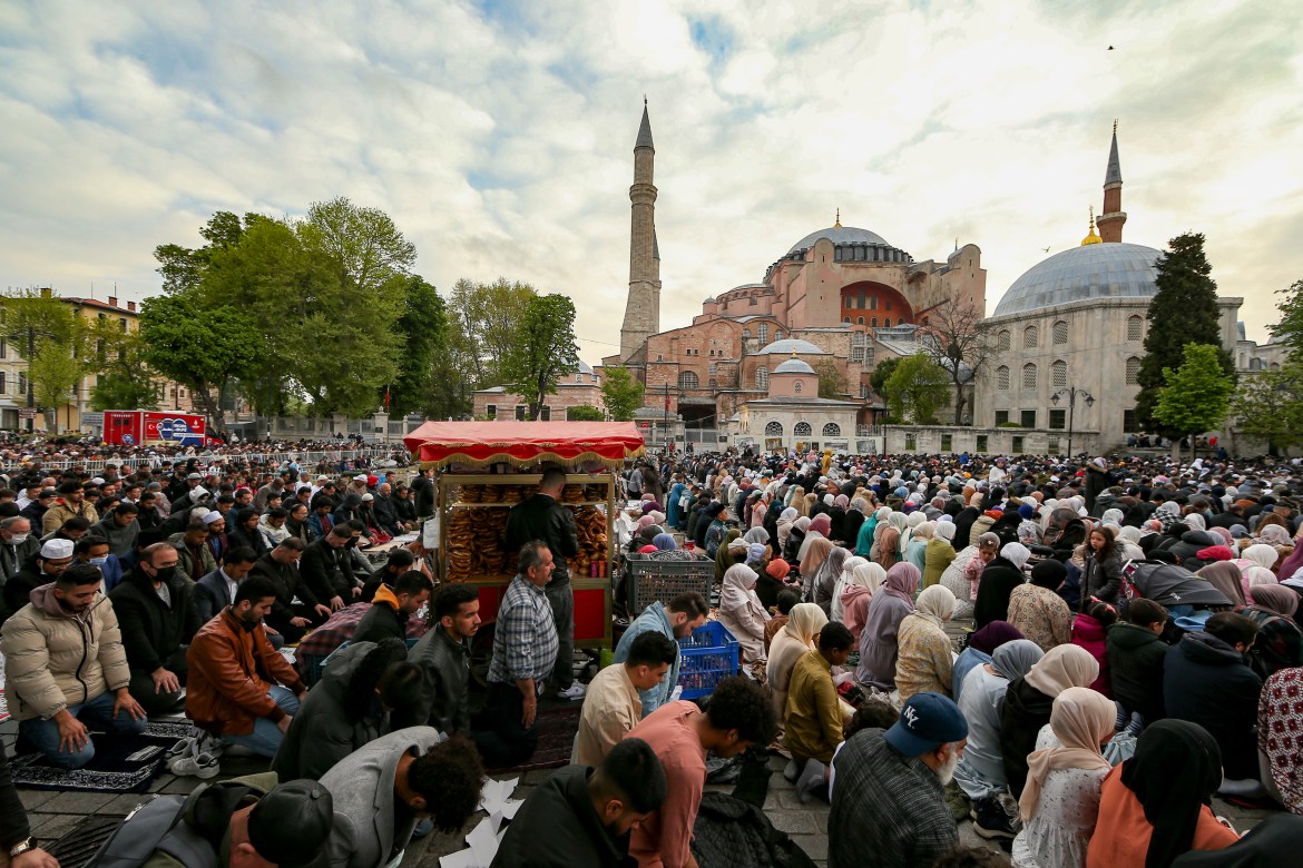 Muslims offer prayers during the first day of Eid al-Fitr, which marks the end of the holy month of Ramadan outside the iconic-historic Haghia Sophia Mosque in Istanbul