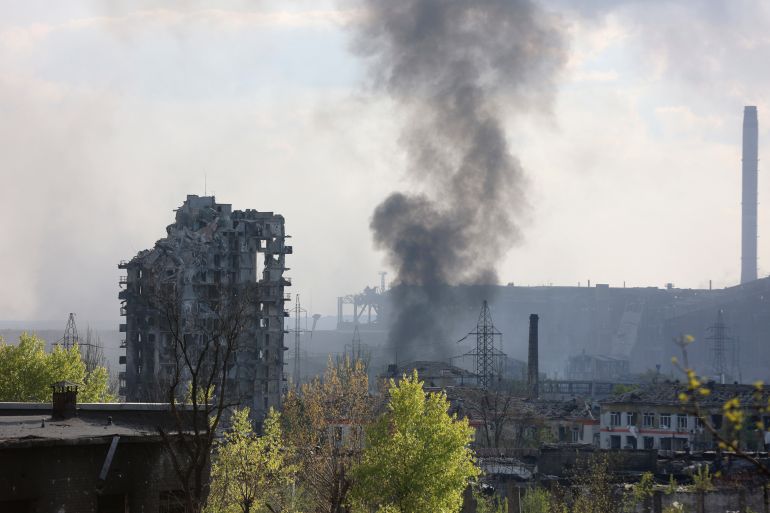 Black smoke rises from the ruined buildings of the Azovstal plant in the Ukrainian city of Mariupol