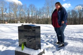 Deb Walker visits the grave of her daughter, Brooke Goodwin, Thursday, Dec. 9, 2021, in Chester, Vt. Goodwin, 23, died in March of 2021 of a fatal overdose of the powerful opioid fentanyl and xylazine, an animal tranquilizer that is making its way into the illicit drug supply.