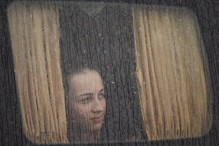 A refugee fleeing the conflict from neighbouring Ukraine sits on a bus