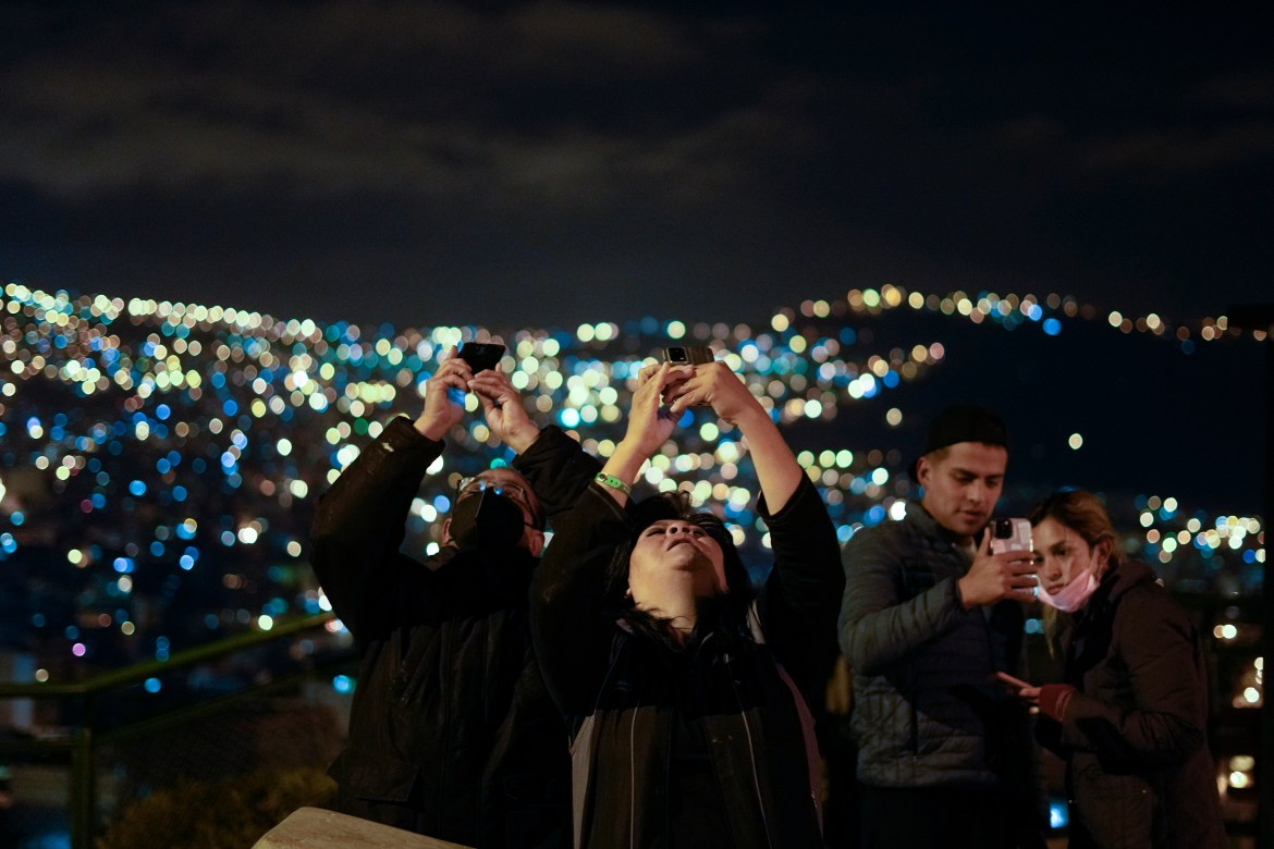 People take photos of the first blood moon lunar eclipse of the year at the Killi Killi lookout in La Paz, Bolivia