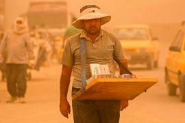 A street vendor sells cigarettes during a sandstorm in Baghdad, Iraq, Monday, May 16, 2022.