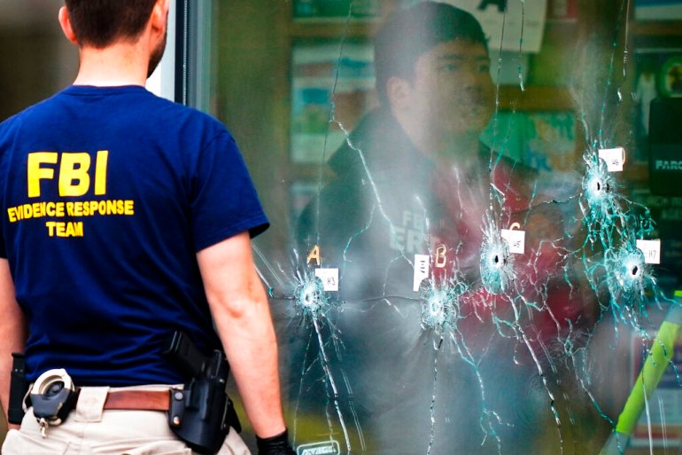 FBI Investigators work the scene of a shooting at a supermarket, in Buffalo, N.Y.
