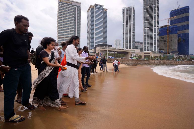 Human rights activists walk to offer flowers to the sea in remembrance of victims of Sri Lanka's civil war.