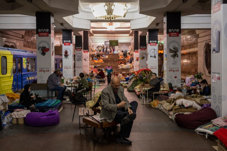 People take shelter in a metro station in the city of Kharkiv 