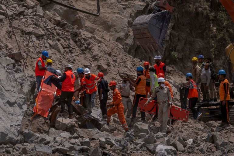 Rescue workers prepare to retrieve the body of a victim at the site of a collapsed tunnel in Ramban district, south of Srinagar, Indian controlled Kashmir on May 20, 2022 [Dar Yasin/AP]