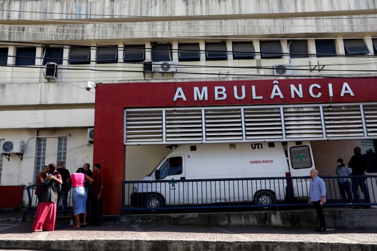 People wait outside a hospital in Rio de Janeiro, Brazil