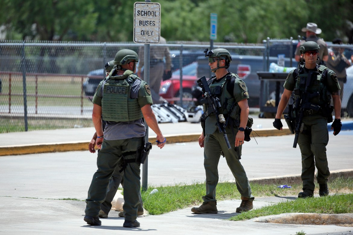 Law enforcement personnel stand outside Robb Elementary School following a shooting