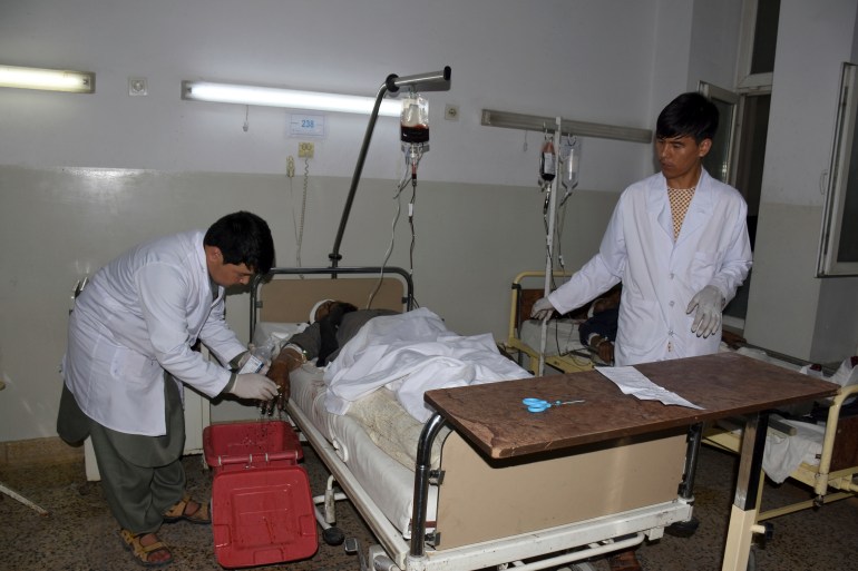 A wounded man receives treatment in a hospital, after a bombing in Mazar-e-Sharif, northern Afghanistan