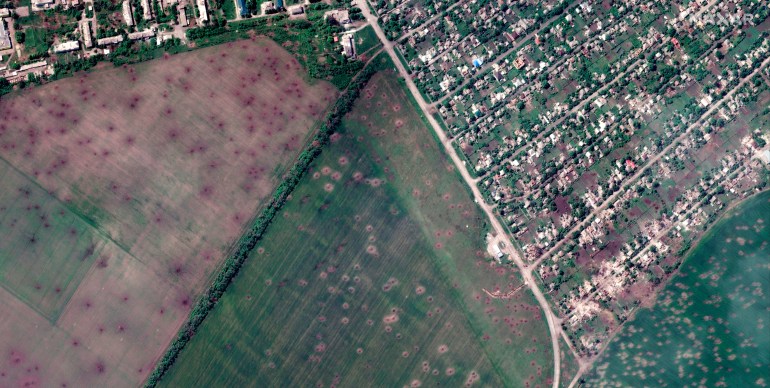 satellite image provided by Maxar Technologies shows an overview of artillery craters in fields and destroyed buildings from recent artillery shelling, in Lyman, Ukraine