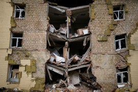 Debris hangs from a residential building heavily damaged in a Russian bombing in Bakhmut, eastern Ukraine,