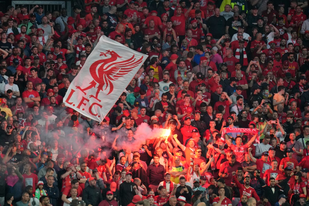 Liverpool fans light flares prior to the start of the Champions League final soccer match between Liverpool and Real Madrid at the Stade de France in Saint Denis near Paris