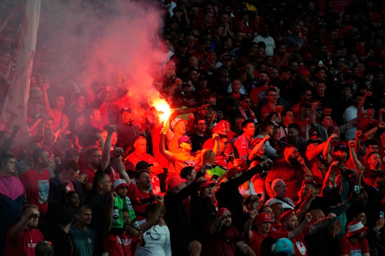 Liverpool supporters light flares during the Champions League final soccer match between Liverpool and Real Madrid at the Stade de France in Saint Denis near Paris