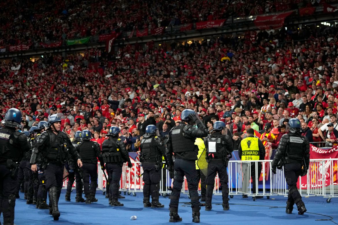 Riot police watch Liverpool fans during the Champions League final soccer match between Liverpool and Real Madrid at the Stade de France in Saint Denis near Paris
