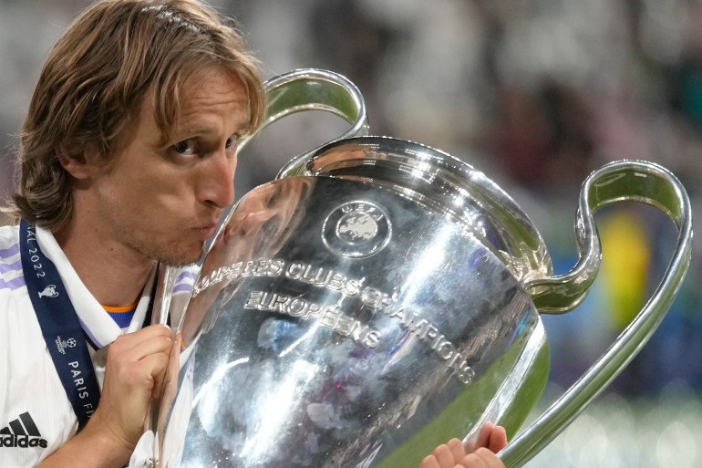 Real Madrid's Luka Modric kisses the trophy after winning the Champions League final soccer match between Liverpool and Real Madrid at the Stade de France near Paris [Kirsty Wigglesworth/AP]