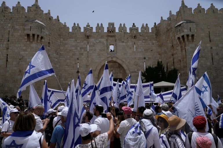 Israelis wave national flags in front of Damascus Gate in East Jerusalem.