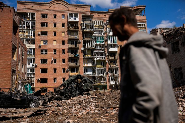 A man walks next to heavily damaged buildings and destroyed cars following Russian attacks in Bakhmut, Donetsk region, eastern Ukraine.