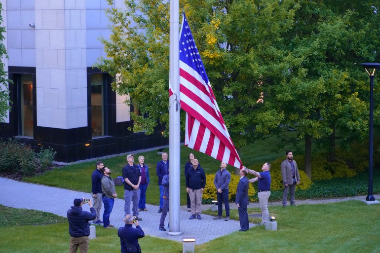 Employees of US embassy in Ukraine raise the US flag at the US embassy in Kyiv,