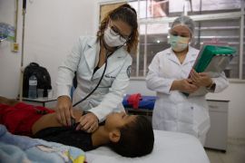 Dr Carla Carvalho checks the heartbeat of a 4-year-old patient in Macapa, Brazil
