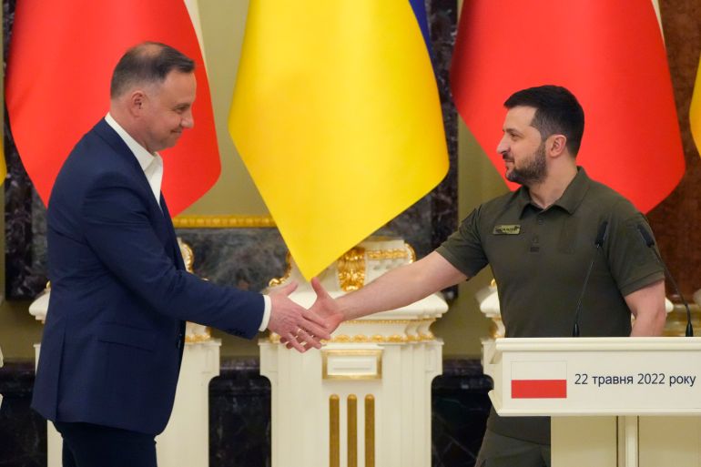 Ukrainian President Volodymyr Zelenskyy, right, and Polish President Andrzej Duda, shake hands during a news conference after their meeting in Kyiv, Ukraine, Sunday, May 22, 2022