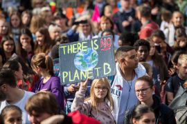 protester seen with a sign that reads 'there is no planet B'