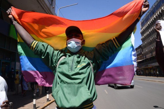 Protester with mask and rainbow flag