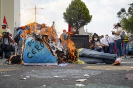 An effigy depicting President of El Salvador Nayib Bukele is set on fire during a demonstration on May 1, 2022 in San Salvador, El Salvador. [Camilo Freedman/ APHOTOGRAFIA/Getty Images]