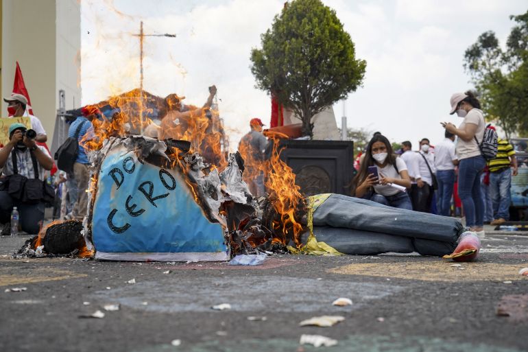 An effigy depicting President of El Salvador Nayib Bukele is set on fire