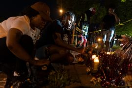 People honour victims of Buffalo massacre with candles at a memorial