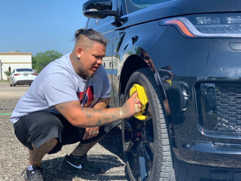 Omar Rodriguez washes a car at Uvalde's fundraiser