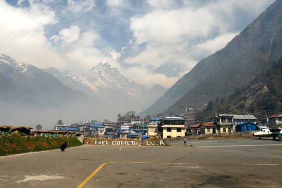 A Twin Otter passenger aircraft at Lukla airport with Mount Everest in the background in east Nepal.