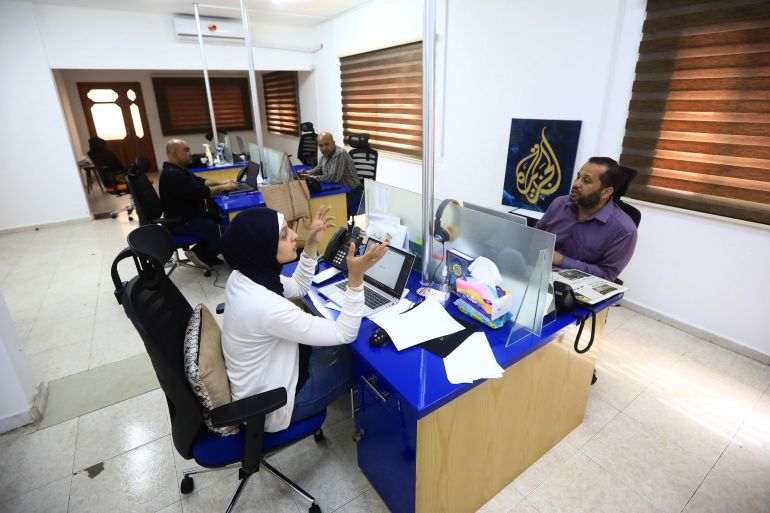 Journalists in Al-Jazeera temorary office discuss the events.
