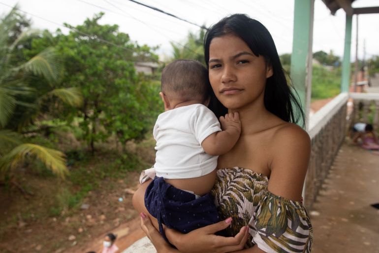Pamela Serrao cradles her baby Arthur in their home in Santana, Brazil 