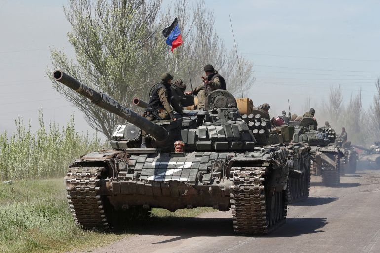Russian troops drive armoured vehicles near Novoazovsk in the Donetsk region on Friday