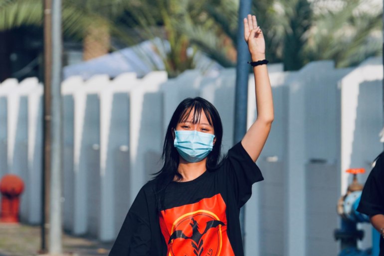Tawan, in a black t-short with red print gives the three-fingered Hunger Games salute which has become a symbol of resistance in Asia 