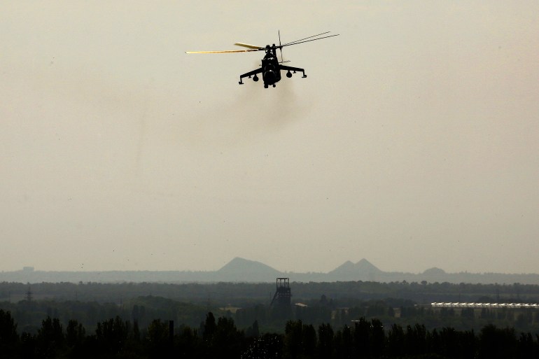A Ukrainian Mi-24 gunship manoeuvres over a residential area near Donetsk international airport.