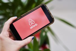 AirBnb Inc. signage is displayed on an smartphone in an arranged photograph taken in the Brooklyn borough of New York, U.S.