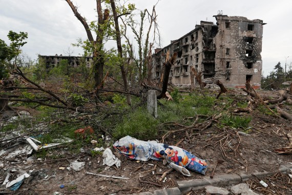A covered body in a residential area near Azovstal Iron and Steel Works, in the destroyed southern port city of Mariupol,