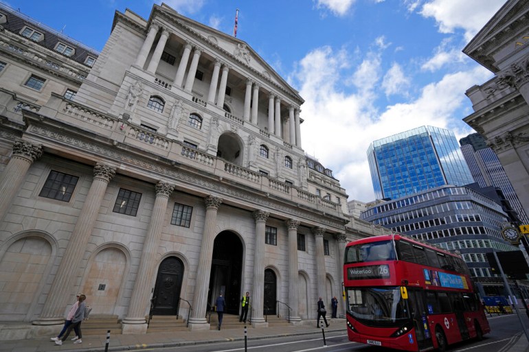 A bus drives past the Bank of England before the release of the Monetary Policy Report at the Bank of England in London