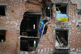 Residents take out their belongings from their house ruined by the Russian shelling in Irpin close to Kyiv, Ukraine, Saturday, May 21, 2022 [Efrem Lukatsky/AP]