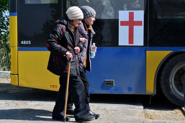 Women board a bus during an evacuation of civilians on a road near Slovyansk, eastern Ukraine