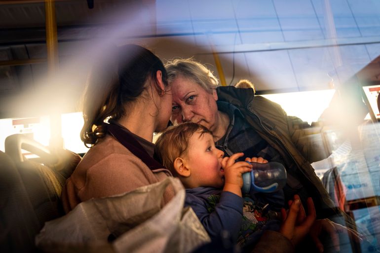 People with children after arriving from the Ukrainian city of Mariupol at a centre for displaced people in Zaporizhzhia.
