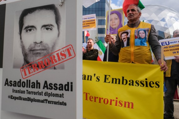 Iranian opposition activists, members of the National council of Resistance of Iran, protest with portrait depicting Iranian official Asadollah Assadi, in Brussels, Belgium