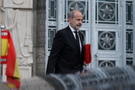 Spanish Ambassador to Russia Marcos Gomez Martinez leaves Russia's foreign ministry with a red folder under his arm