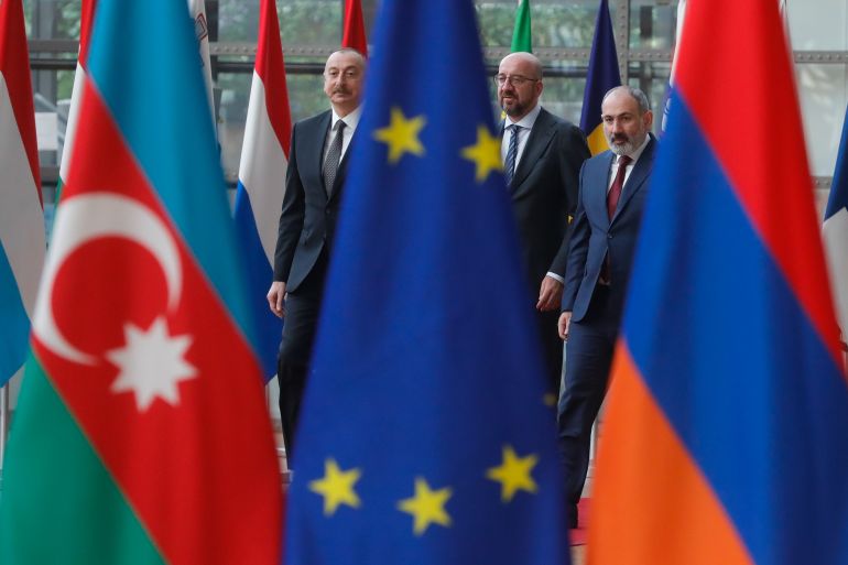 Azerbaijani President Ilham Aliyev (L) and Armenian Prime Minister Nikol Pashinyan are welcomed by the President of the European Council Charles Michel (C) in Brussels