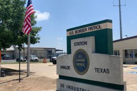 A US flag flies at half-mast outside a US Border Patrol Station in Uvalde, Texas